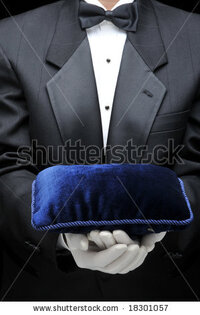 stock-photo-butler-holding-a-velvet-pillow-in-front-of-his-torso-183010571.jpg