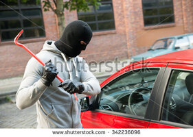 stock-photo-thief-with-mask-trying-to-smash-the-window-of-the-car-with-crowbar-342236096.jpg